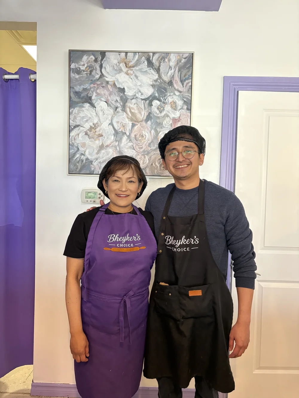 The owners of Bheyker's Choice Filipino Bakery NE Calgary in their branded aprons