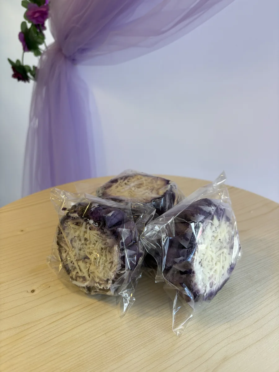 Ube ensaymada — Filipino purple yam brioche pastry with cream cheese frosting at Bheyker's Choice NE Calgary
